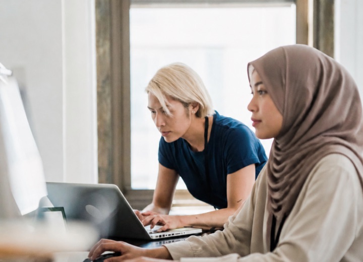 Two people working together at a laptop